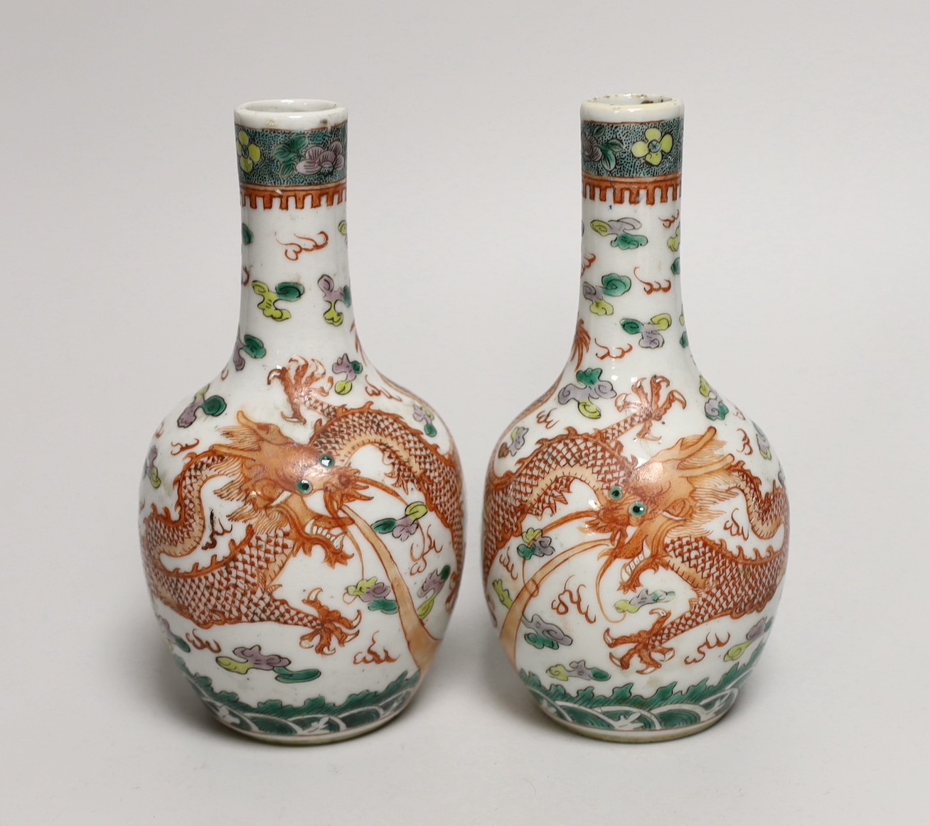 A pair of Chinese enamelled porcelain ‘dragon’ bottle vases, Kangxi marks probably Guangxu period, 15cms high (a.f.)